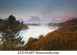 Mist over river in rural landscape