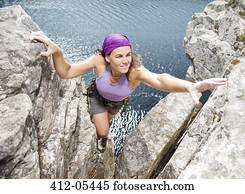 Climber scaling rock formation