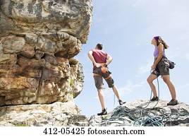 Climbers examining rock formation