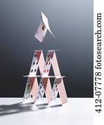 Cards jumping above house of cards