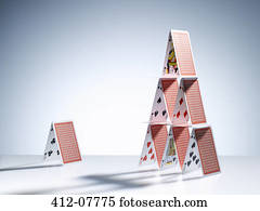 Small house of cards next to large house of cards