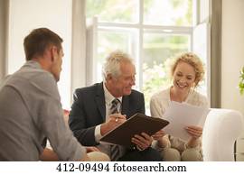 Financial advisor talking to couple in living room