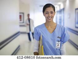 Portrait of smiling nurse in hospital corridor