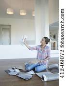 Woman viewing paint swatches in new house