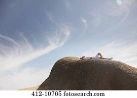 Man relaxing on rock formation
