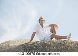 Man sitting on rock formation