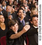 Theater audience videoing performance with smart phones