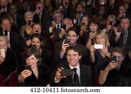 Theater audience videoing performance with smart phones