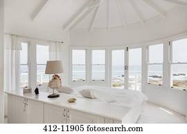 White bedroom overlooking ocean
