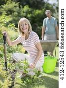 Senior couple working in garden