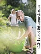 Senior couple working in garden