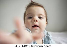 Baby girl reaching out