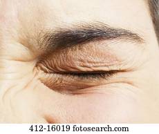 Extreme close up of girl squinting eye