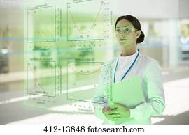 Serious doctor with clipboard in hospital Serious doctor with clipboard in hospital