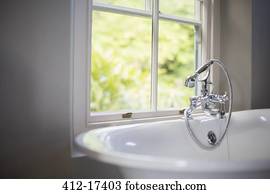 Soaking tub at window in bathroom