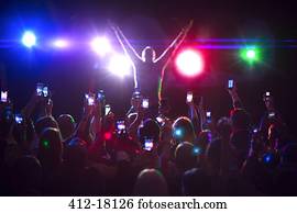 Audience photographing musician on stage