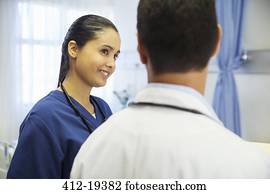 Doctor and nurse talking in hospital room Doctor and nurse talking in hospital room