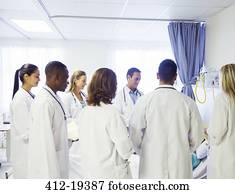Doctor and residents examining patient in hospital Doctor and residents examining patient in hospital