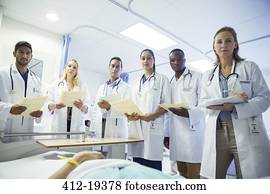 Doctor and residents examining patient in hospital bed Doctor and residents examining patient in hospital bed