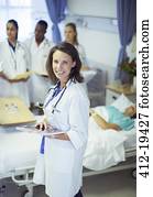 Doctor holding digital tablet in hospital room