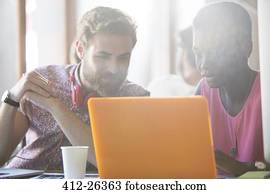 Casual business people working at laptop