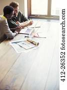 Creative business people working at laptop in office