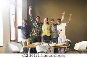 Portrait waving creative business people in office