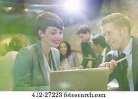 Business people working at laptop in office