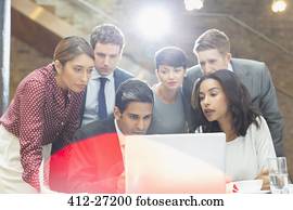 Business people working at laptop in office