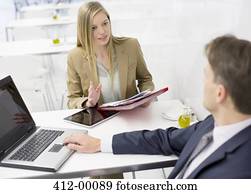 Businessman and businesswoman discussing paperwork