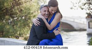 Happy well-dressed couple hugging