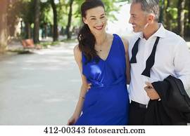 Smiling well-dressed couple in park