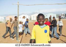 Boy smiling in dirt field
