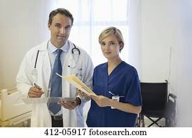 Doctor and nurse talking in hospital room Doctor and nurse talking in hospital room