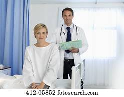 Doctor and patient smiling in hospital room Doctor and patient smiling in hospital room