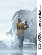 Happy woman walking barefoot in rain