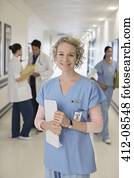 Portrait of smiling nurse in hospital corridor