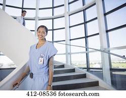 Portrait of smiling nurse on stairs