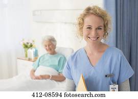 Portrait of smiling nurse with senior patient in background