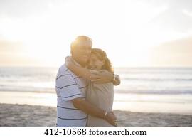 Senior couple hugging on beach