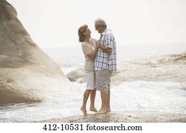 Senior couple hugging on beach
