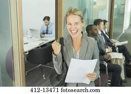 Businesswoman cheering in office