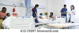 Doctor, nurses and patients in hospital room Doctor, nurses and patients in hospital room