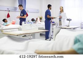 Doctor, nurses, and patients in hospital room