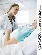 Doctor talking to patient in hospital room Doctor talking to patient in hospital room