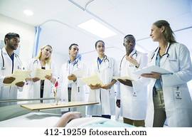 Doctor teaching residents in hospital room