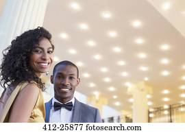 Portrait of well dressed smiling couple