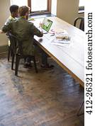 Business people working at laptop in office