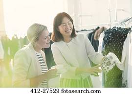 Fashion designers examining cuff detail on blouse