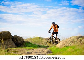 Cyclist Riding the Bike on the Beautiful Mountain Trail Cyclist Riding the Bike on the Beautiful Mountain Trail